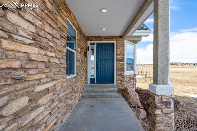 doorway to property featuring stone siding