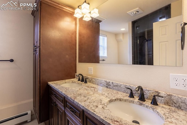 full bathroom featuring double vanity, a baseboard heating unit, and a sink