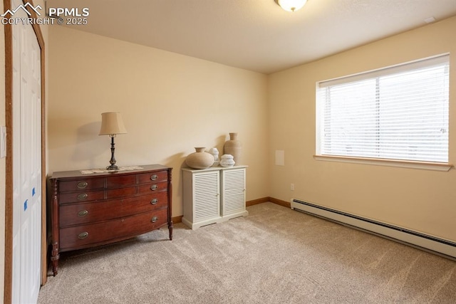 bedroom featuring light carpet, a baseboard radiator, and baseboards