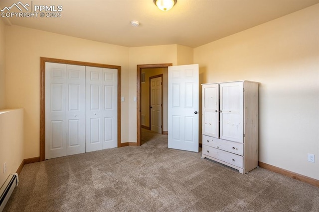 unfurnished bedroom with carpet floors, baseboard heating, a closet, and baseboards