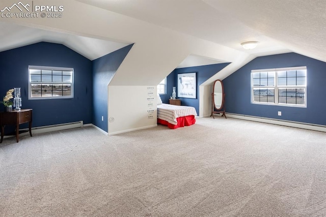 unfurnished bedroom featuring lofted ceiling, a baseboard radiator, carpet floors, and baseboards