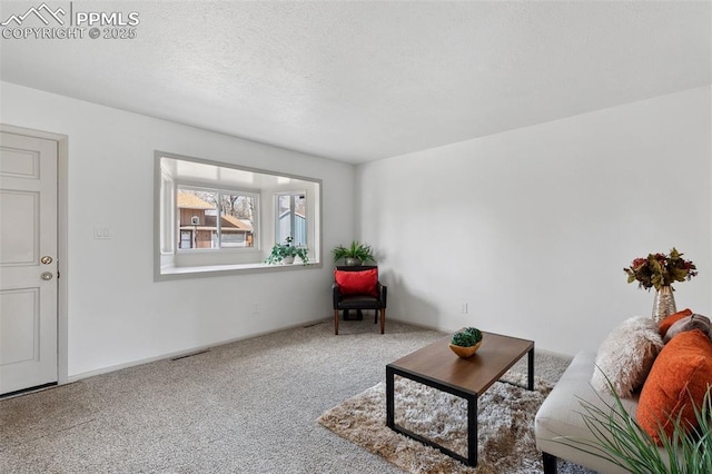 carpeted living area with visible vents and a textured ceiling