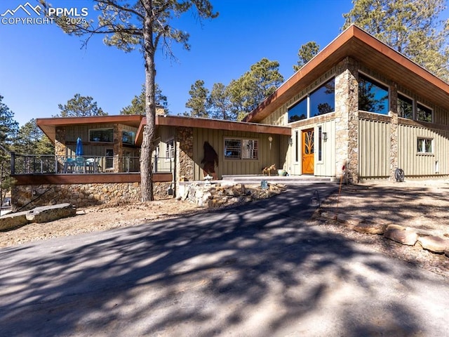 rustic home with stone siding and board and batten siding