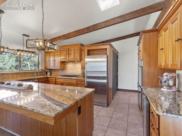 kitchen with stainless steel appliances, beamed ceiling, light stone counters, and tasteful backsplash