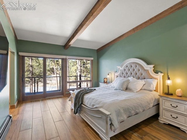 bedroom featuring a baseboard radiator, beamed ceiling, and wood finished floors