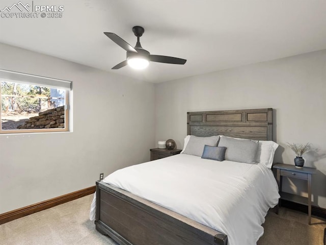 bedroom with light carpet, a ceiling fan, and baseboards