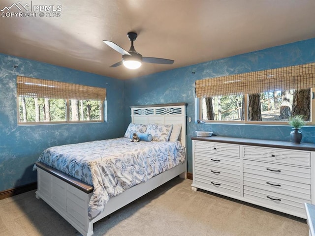 carpeted bedroom featuring a ceiling fan, baseboards, and wallpapered walls