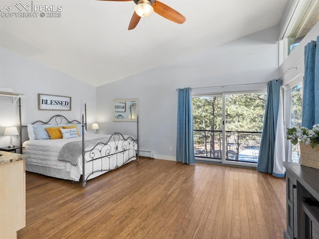 bedroom with ceiling fan, multiple windows, baseboard heating, and wood finished floors