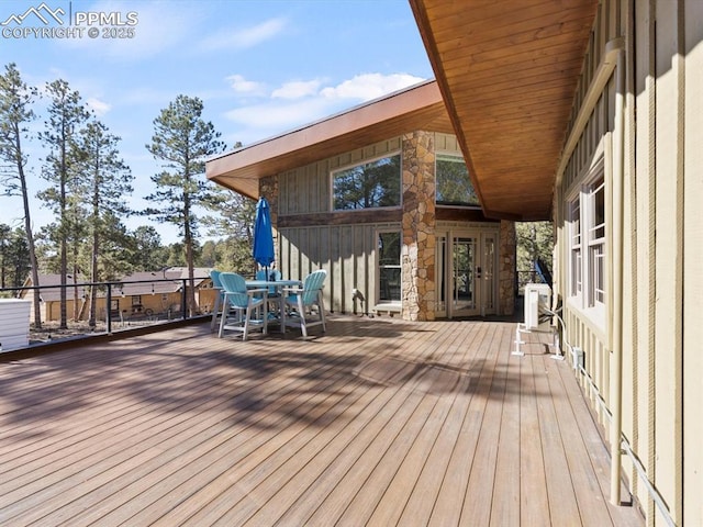 wooden terrace with outdoor dining space