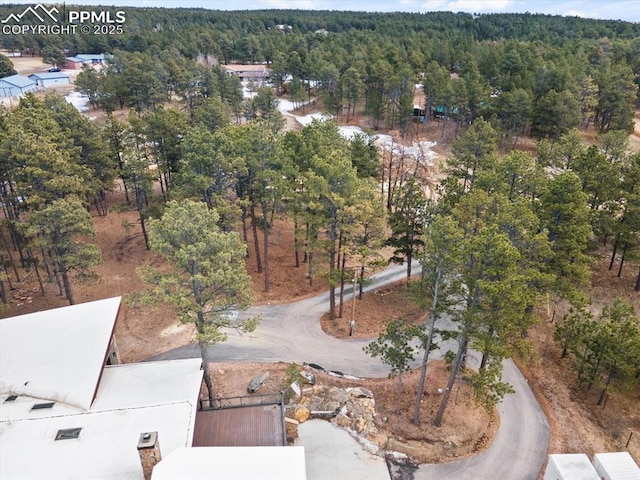 birds eye view of property with a wooded view