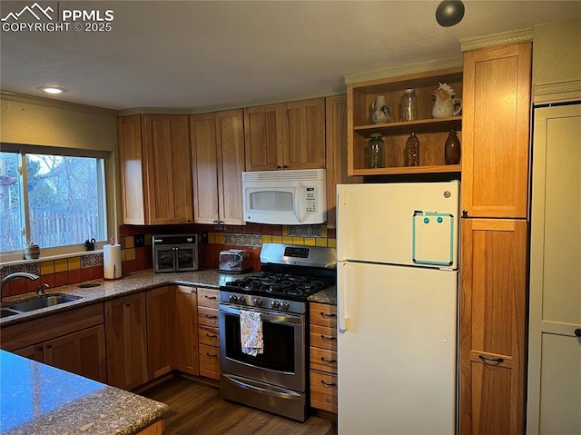 kitchen featuring open shelves, white appliances, a sink, and brown cabinets