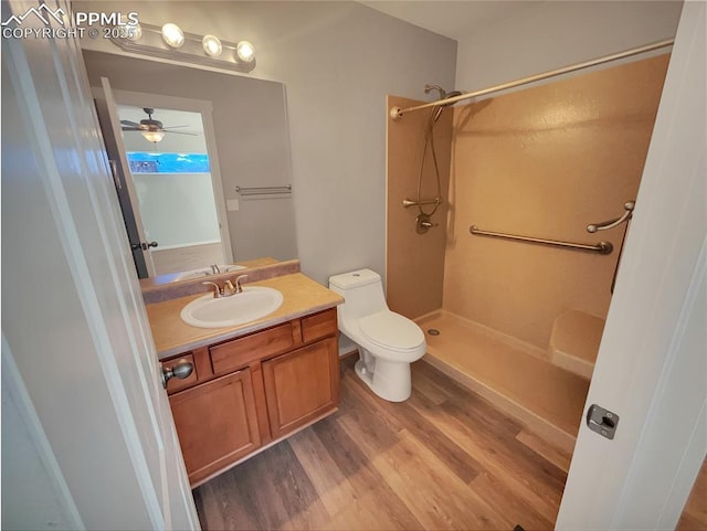 full bath with a shower, vanity, toilet, and wood finished floors