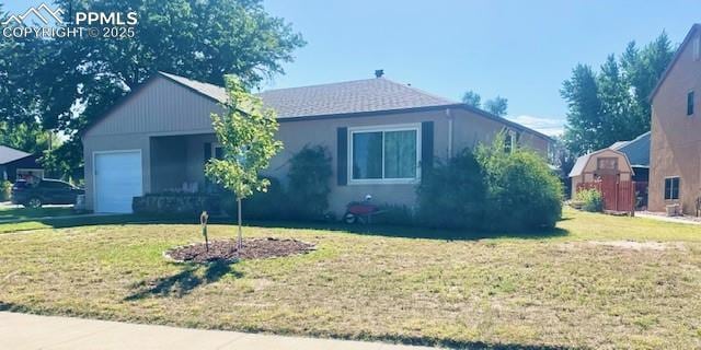 ranch-style house featuring an attached garage and a front yard