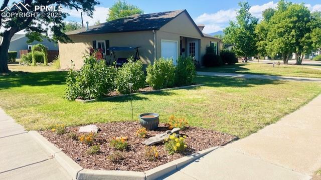 view of home's exterior with a lawn and stucco siding