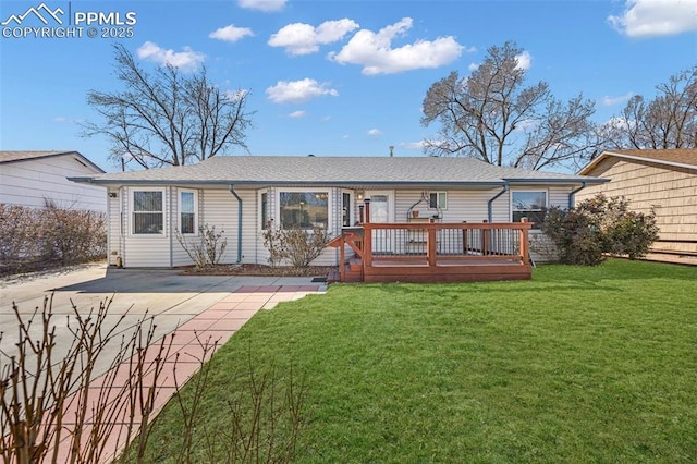 back of property featuring a lawn and a wooden deck