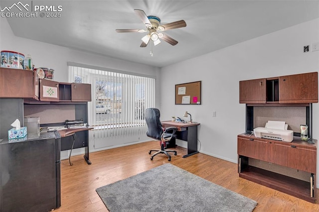 office area with light wood finished floors, ceiling fan, and baseboards