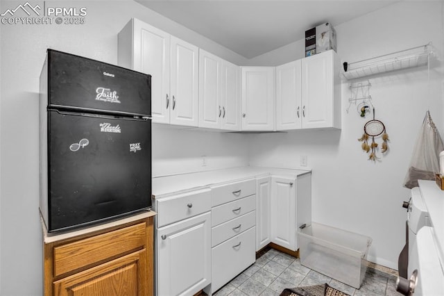 kitchen with light countertops and white cabinets