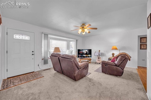 living area featuring a ceiling fan and light carpet