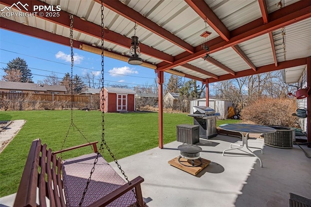 view of patio with a storage shed, a fenced backyard, and an outdoor structure