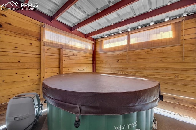 interior space featuring wood walls, a sauna, and beamed ceiling