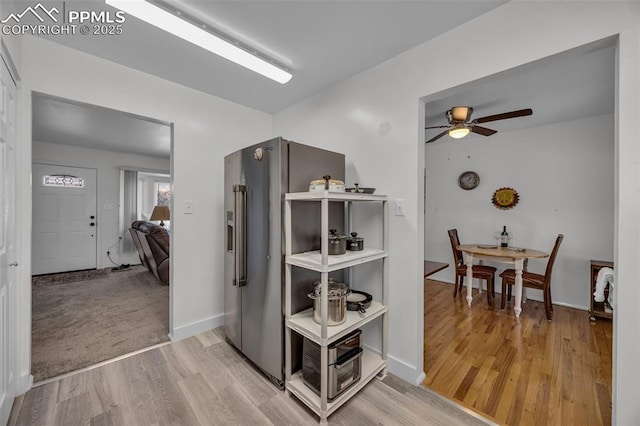 hallway with baseboards and wood finished floors