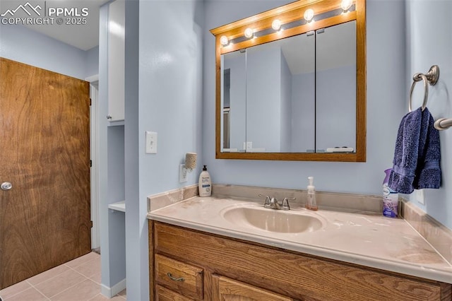 bathroom featuring tile patterned flooring and vanity