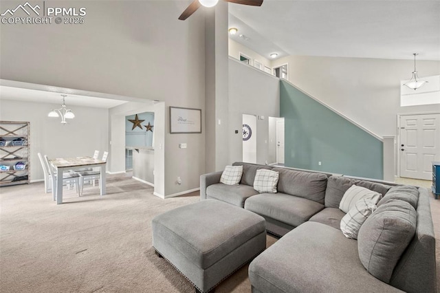 carpeted living room with high vaulted ceiling, ceiling fan, and baseboards