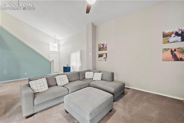 carpeted living room with ceiling fan, high vaulted ceiling, and baseboards