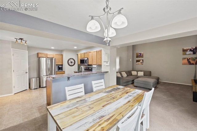 dining space featuring light carpet, an inviting chandelier, baseboards, and recessed lighting