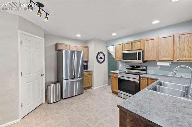 kitchen featuring appliances with stainless steel finishes, recessed lighting, a sink, and baseboards