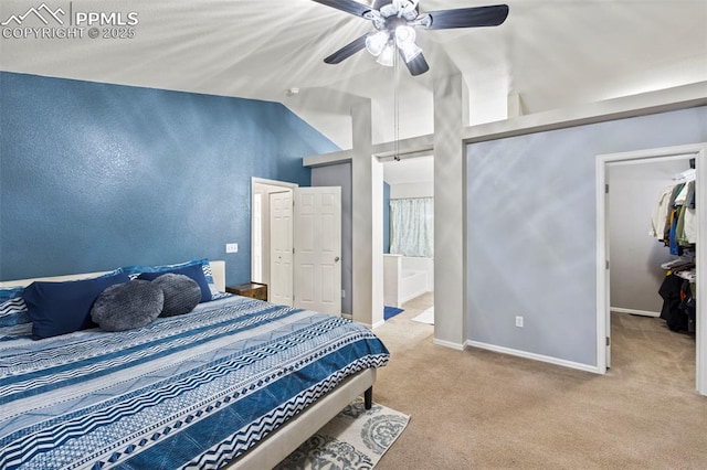 bedroom with baseboards, connected bathroom, lofted ceiling, ceiling fan, and carpet floors