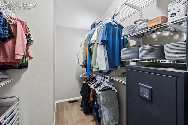 walk in closet featuring carpet floors and visible vents