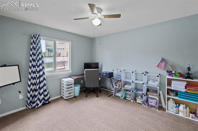 office space with carpet floors, baseboards, and a ceiling fan