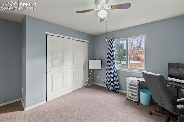 home office featuring carpet, a ceiling fan, and baseboards