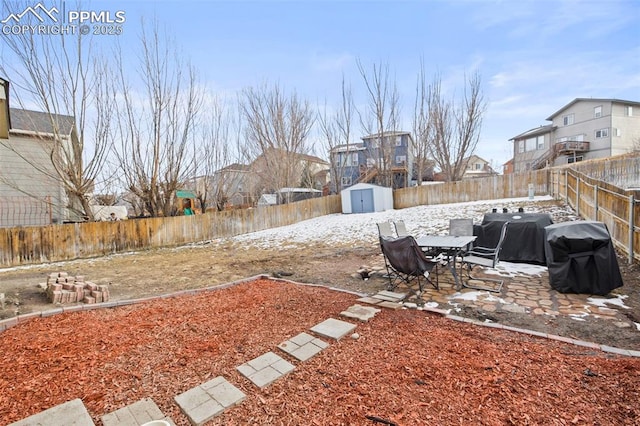 view of yard with a patio area, an outdoor structure, a fenced backyard, and a storage shed