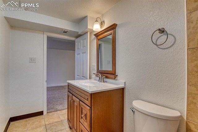 bathroom with visible vents, baseboards, toilet, tile patterned flooring, and vanity