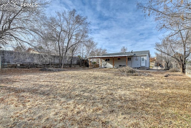 back of house with fence