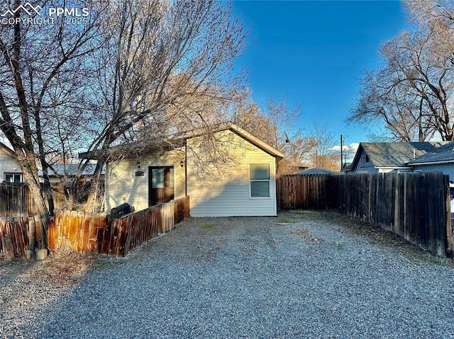 rear view of property featuring fence private yard