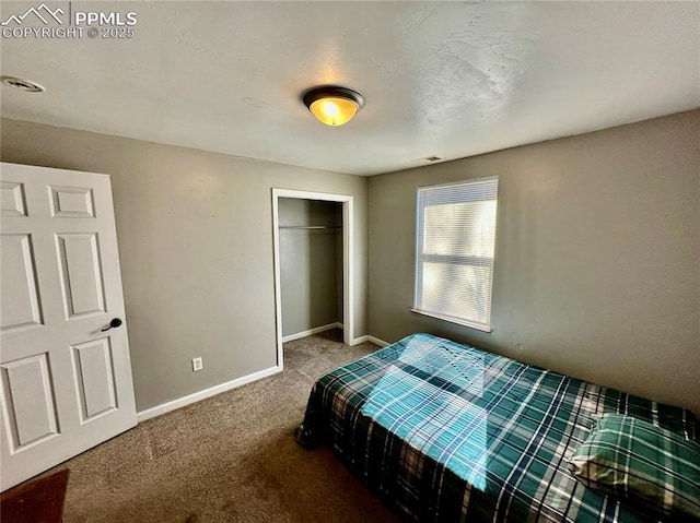 carpeted bedroom with a closet, visible vents, and baseboards