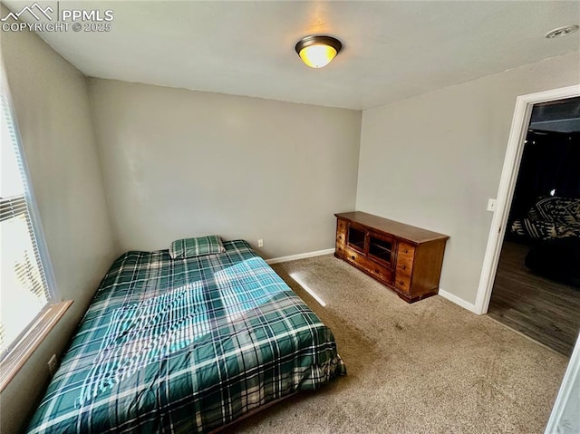 carpeted bedroom with baseboards