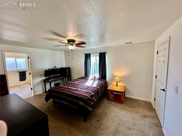 bedroom with carpet, visible vents, baseboards, and ceiling fan