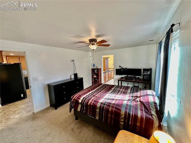 bedroom featuring baseboards, ceiling fan, freestanding refrigerator, and light colored carpet