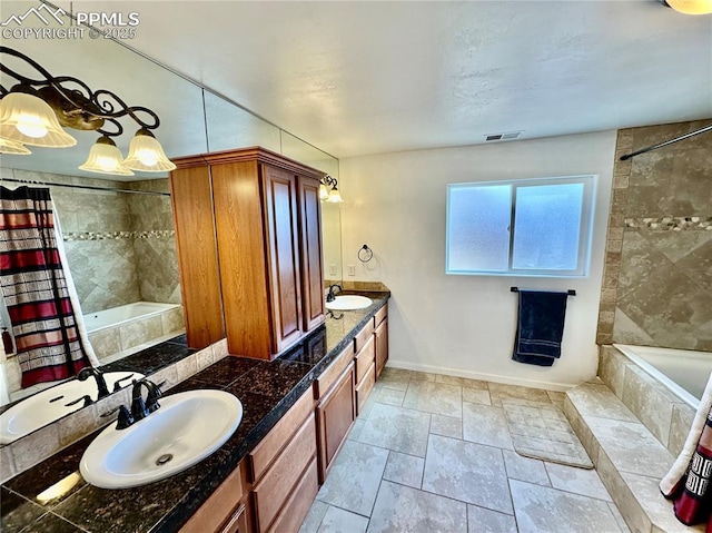 full bath with double vanity, tiled shower / bath combo, a sink, and visible vents