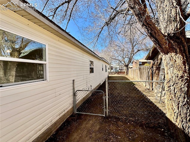 view of side of property featuring a gate and fence