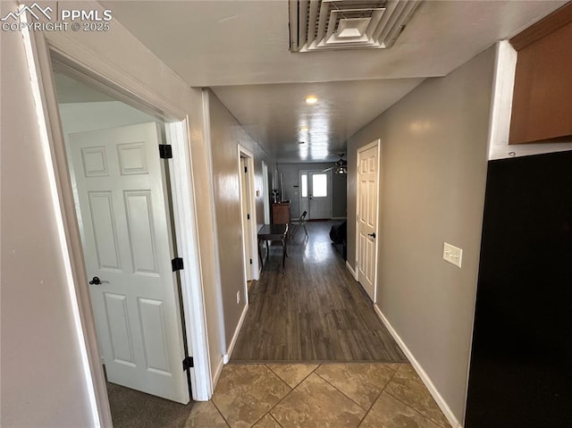 hallway featuring baseboards