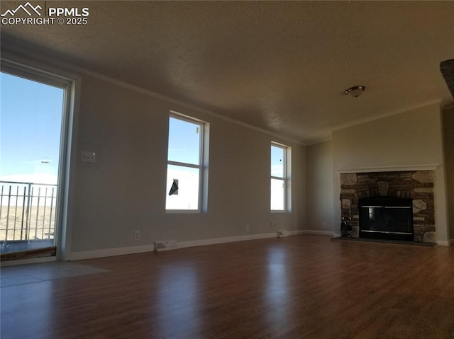 unfurnished living room featuring a fireplace, baseboards, dark wood-style flooring, and crown molding