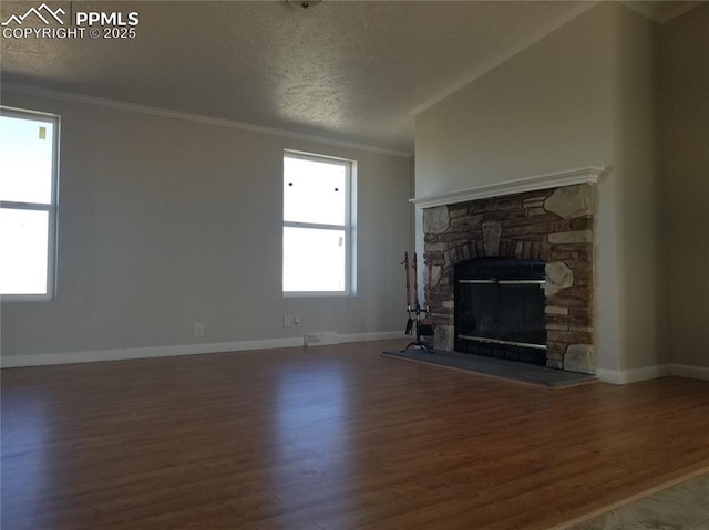 unfurnished living room featuring ornamental molding, a fireplace, wood finished floors, and baseboards