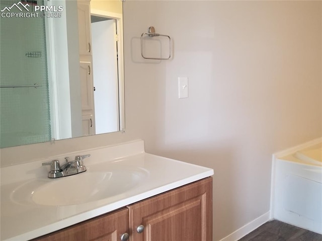 bathroom with baseboards and vanity