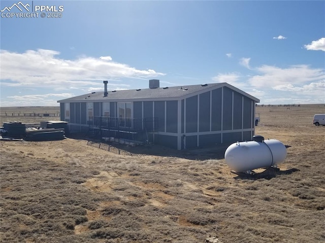 rear view of house featuring a rural view