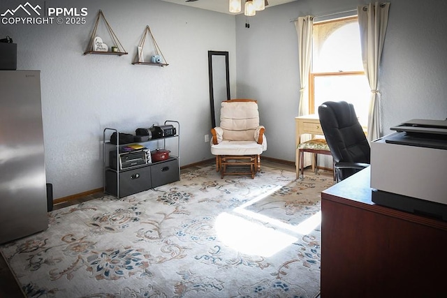 home office featuring a ceiling fan, light carpet, and baseboards